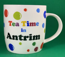 Load image into Gallery viewer, An 11oz bone china  brightly colored polka dot mug that says Teatime in Antrim

