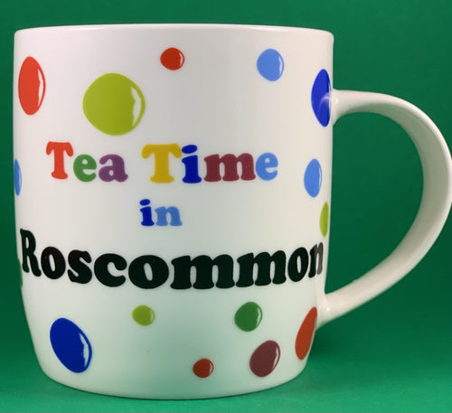 An 11oz bone china  brightly colored polka dot mug that says Teatime in Roscommon