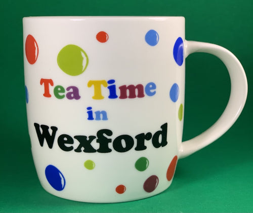 An 11oz bone china  brightly colored polka dot mug that says Teatime in Wexford