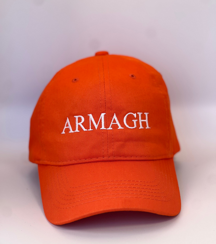 Orange baseball cap with 'ARMAGH' in white embroidery thread. Adjustable back strap with metal clasp.