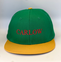 Load image into Gallery viewer, Green and  yellow  trucker style  baseball cap with plastic adjustable back strap. Carlow embroidered in red thread.
