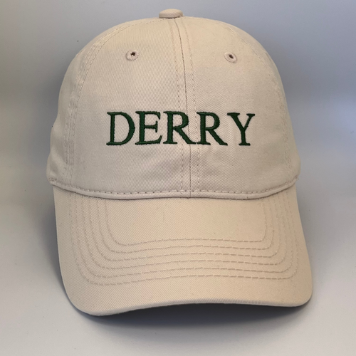 Beige cap with 'DERRY' embroidered in green pn a beige background