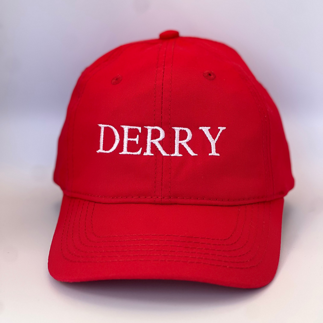 Red cotton baseball cap with 'LOUTH' embroidered in white on red background