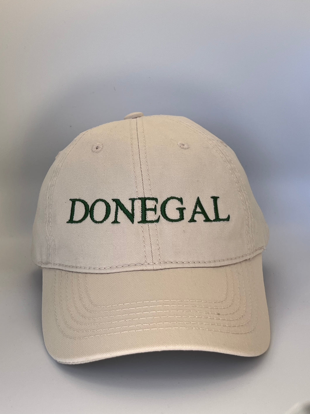 Beige cap with 'DONEGAL' embroidered in green on a beige background