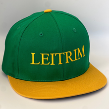 Load image into Gallery viewer, Green trucker style baseball cap with yellow trim.  &#39;Leitrim &#39; embroidered in yellow thread. Adjustable snap back .
