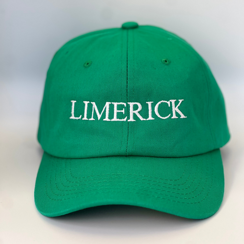 Green baseball cap with 'LIMERICK' embroidered in white thread on a green  background