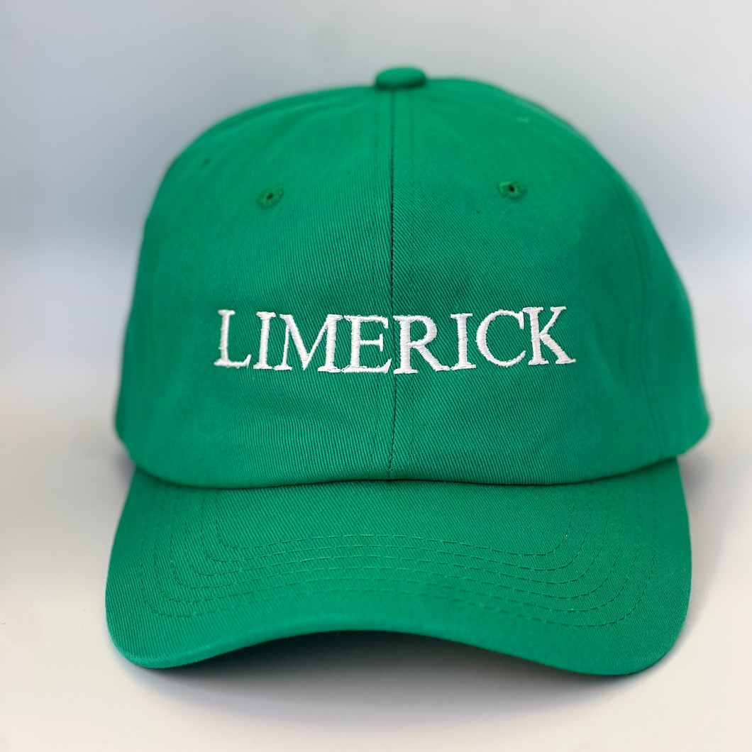 Green baseball cap with 'LIMERICK' embroidered in white thread on a green  background