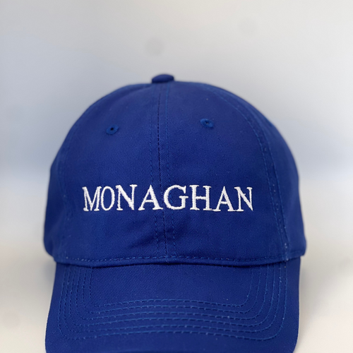 Blue baseball cap with 'MONAGHAN' embroidered in white on a blue background