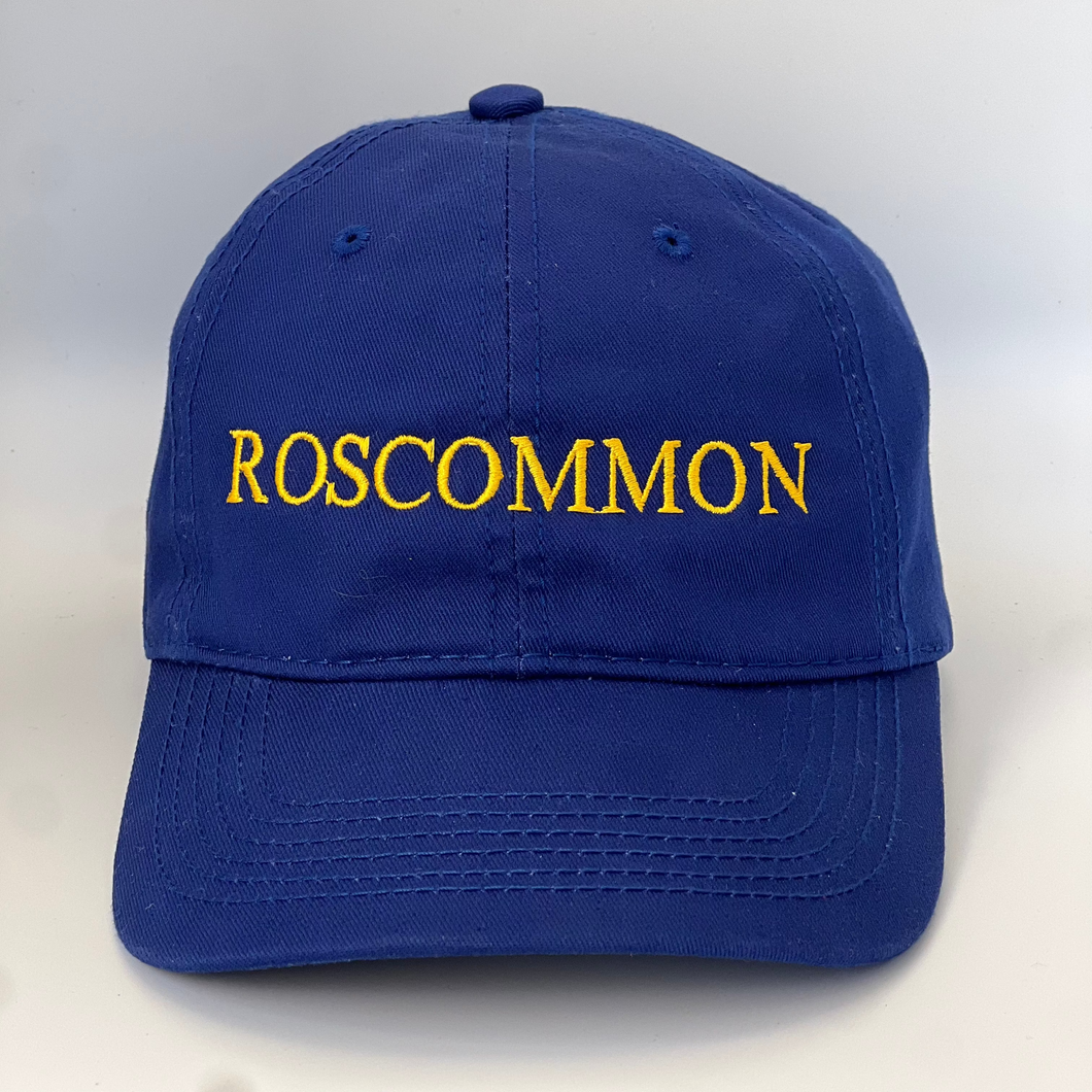 Blue cap with 'ROSCOMMON' embroidered in yellow on a blue background
