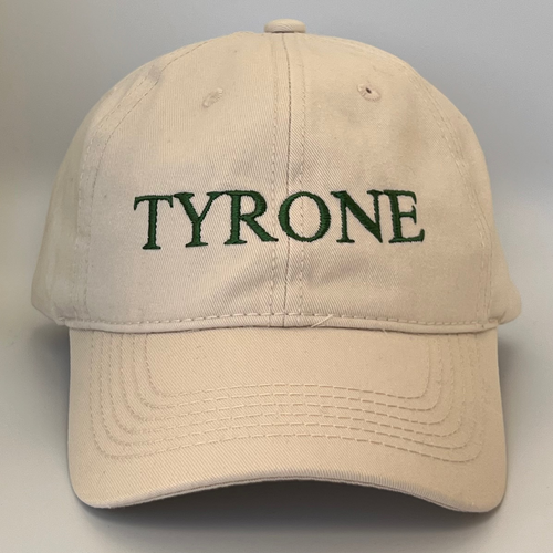 Beige cap with 'TYRONE' embroidered in green on a white background