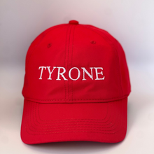 Load image into Gallery viewer, Red baseball cap with &#39;TYRONE&#39; embroidered in white  on a red background
