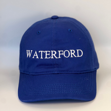 Load image into Gallery viewer, Blue baseball cap with &#39;Waterford&#39; embroidered in white  on a blue background
