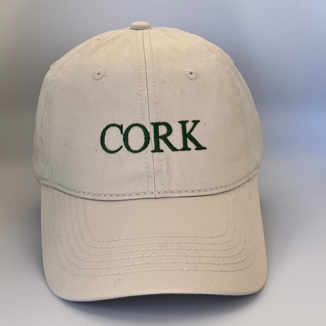Beige cap with 'CORK' embroidered in green on a beige background