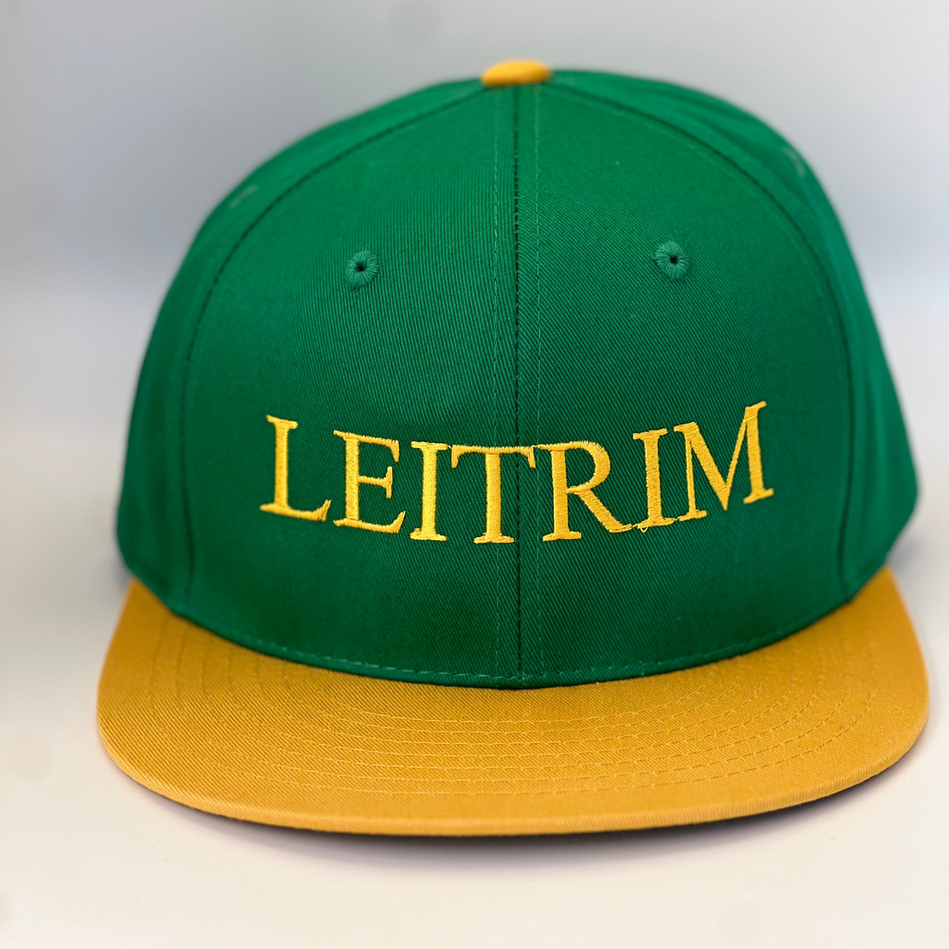 Green trucker style baseball cap with yellow trim.  'leitrim ' embroidered in yellow thread. Adjustable snap back .