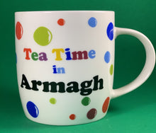 Load image into Gallery viewer, An 11oz bone china  brightly colored polka dot mug that says Teatime in Armagh 
