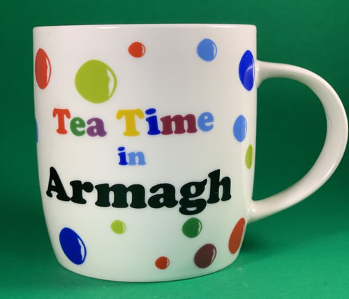 An 11oz bone china  brightly colored polka dot mug that says Teatime in Armagh 