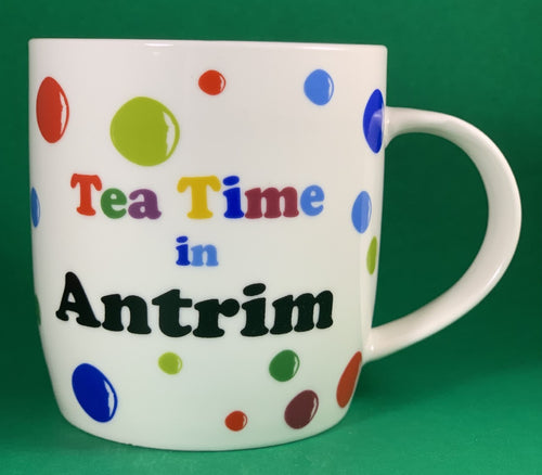 An 11oz bone china  brightly colored polka dot mug that says Teatime in Antrim
