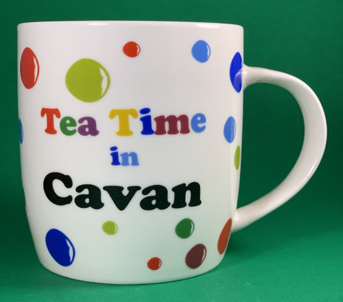 An 11oz bone china  brightly colored polka dot mug that says Teatime in Armagh