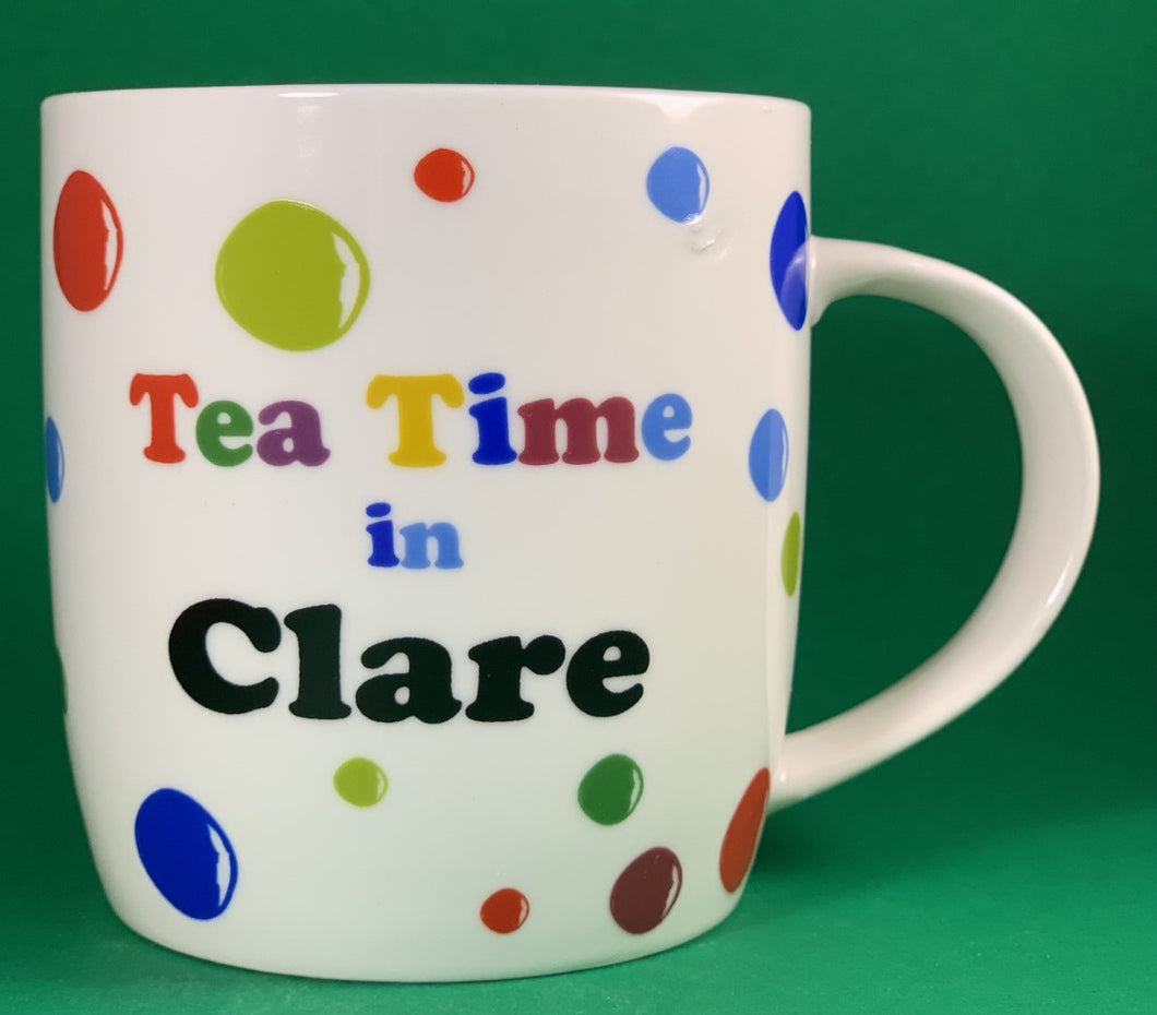An 11oz bone china  brightly colored polka dot mug that says Teatime in Clare