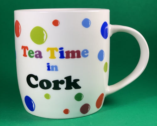 An 11oz bone china  brightly colored polka dot mug that says Teatime in Cork