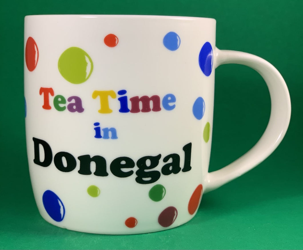 An 11oz bone china  brightly colored polka dot mug that says Teatime in Donegal