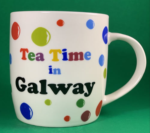 An 11oz bone china  brightly colored polka dot mug that says Teatime in Galway