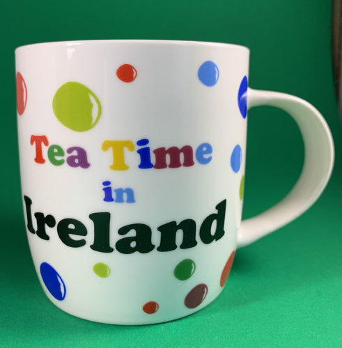 An 11oz bone china  brightly colored polka dot mug that says Teatime in Ireland