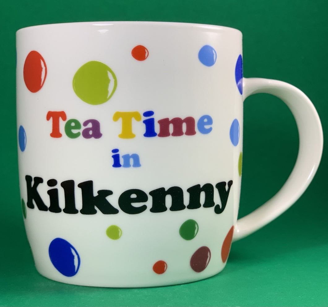 An 11oz bone china  brightly colored polka dot mug that says Teatime in Kilkenny
