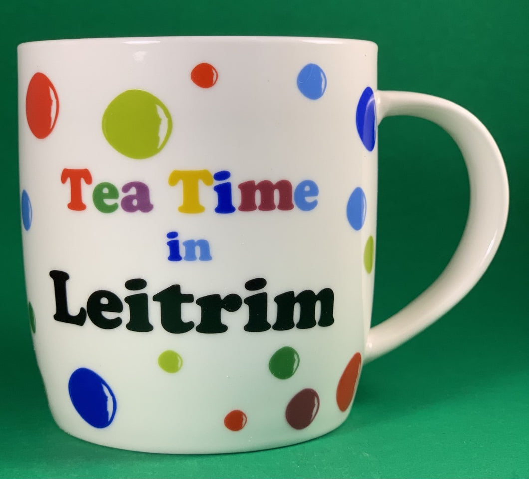 An 11oz bone china  brightly colored polka dot mug that says Teatime in Leitrim