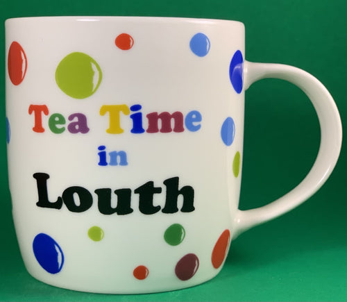An 11oz bone china  brightly colored polka dot mug that says Teatime in Louth