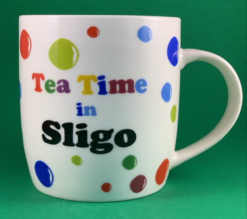 An 11oz bone china  brightly colored polka dot mug that says Teatime in Sligo