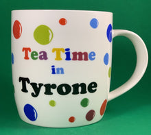 Load image into Gallery viewer, An 11oz bone china  brightly colored polka dot mug that says Teatime in Tyrone
