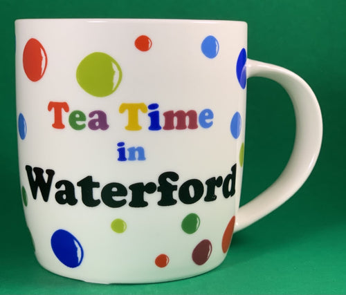 An 11oz bone china  brightly colored polka dot mug that says Teatime in Waterford
