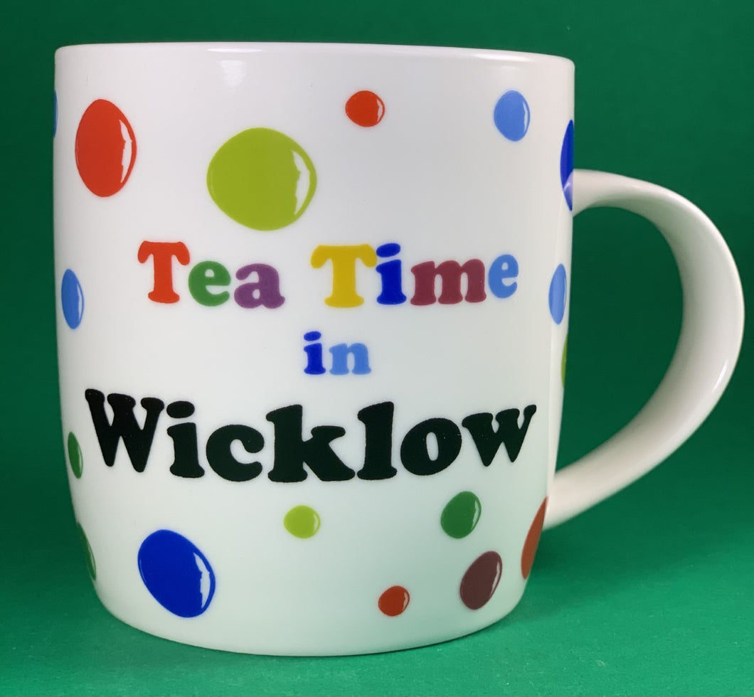 An 11oz bone china  brightly colored polka dot mug that says Teatime in Wicklow